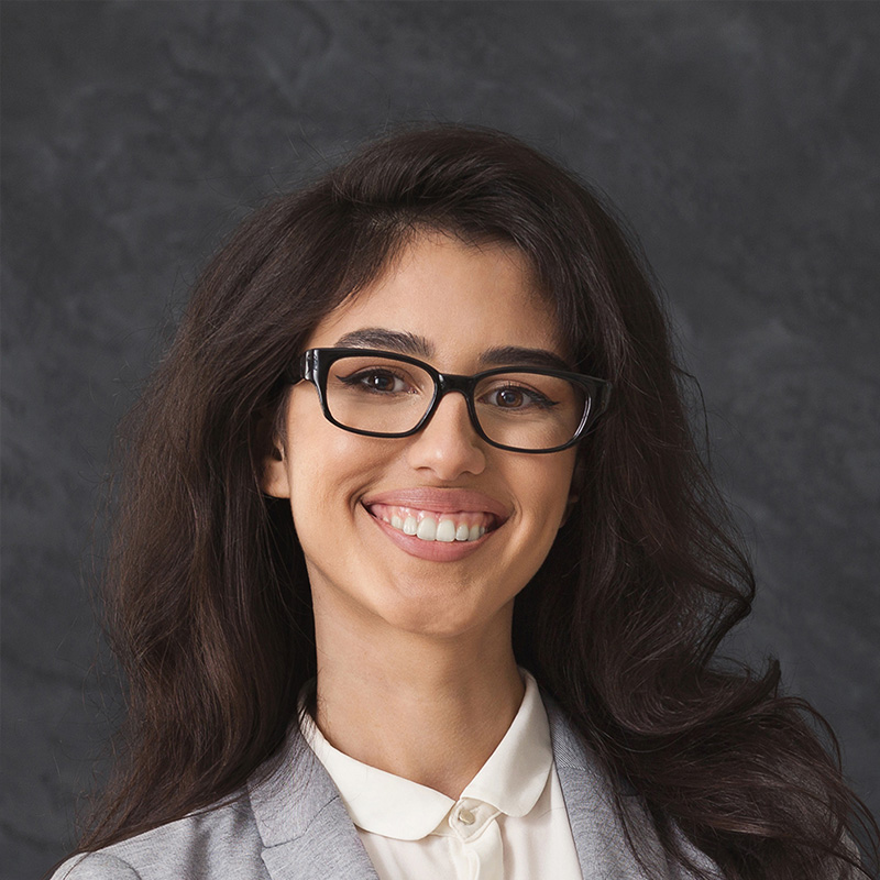 Smiling professional woman wearing glasses and blazer