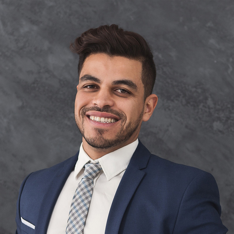Smiling professional headshot in navy suit