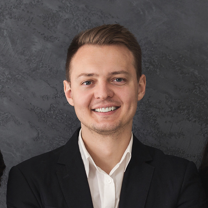 Smiling young professional in black suit jacket