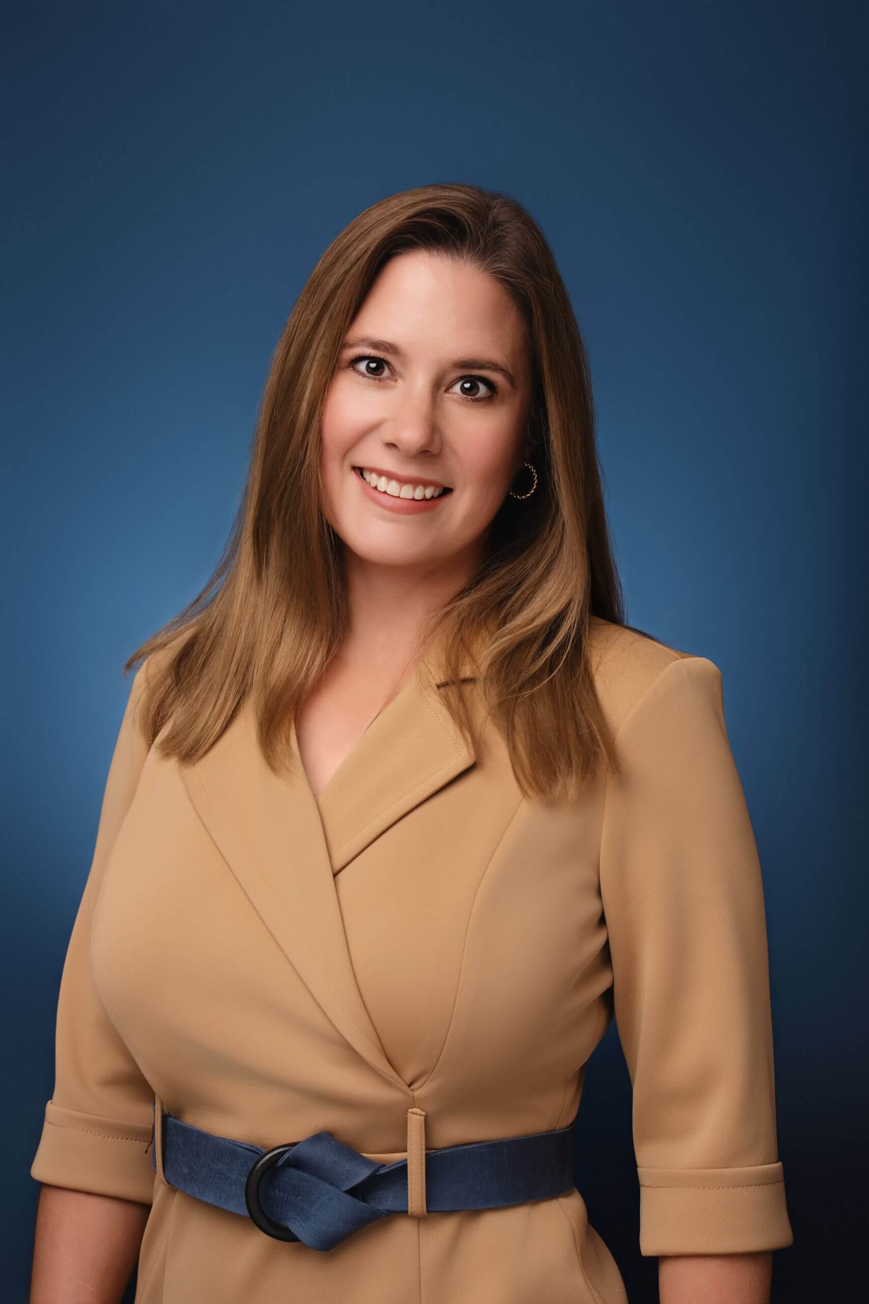 Smiling professional woman wearing tan blazer